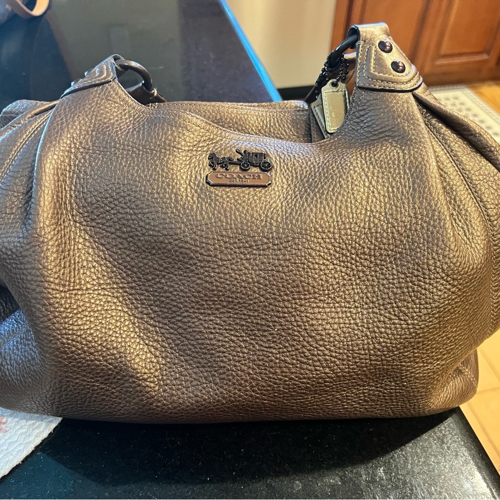 Coach bag beautiful bronze color with deep purple lining.  Pebble leather